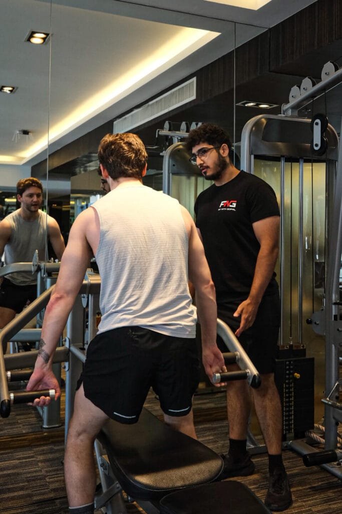 Personal trainer coaching a client in Bangkok