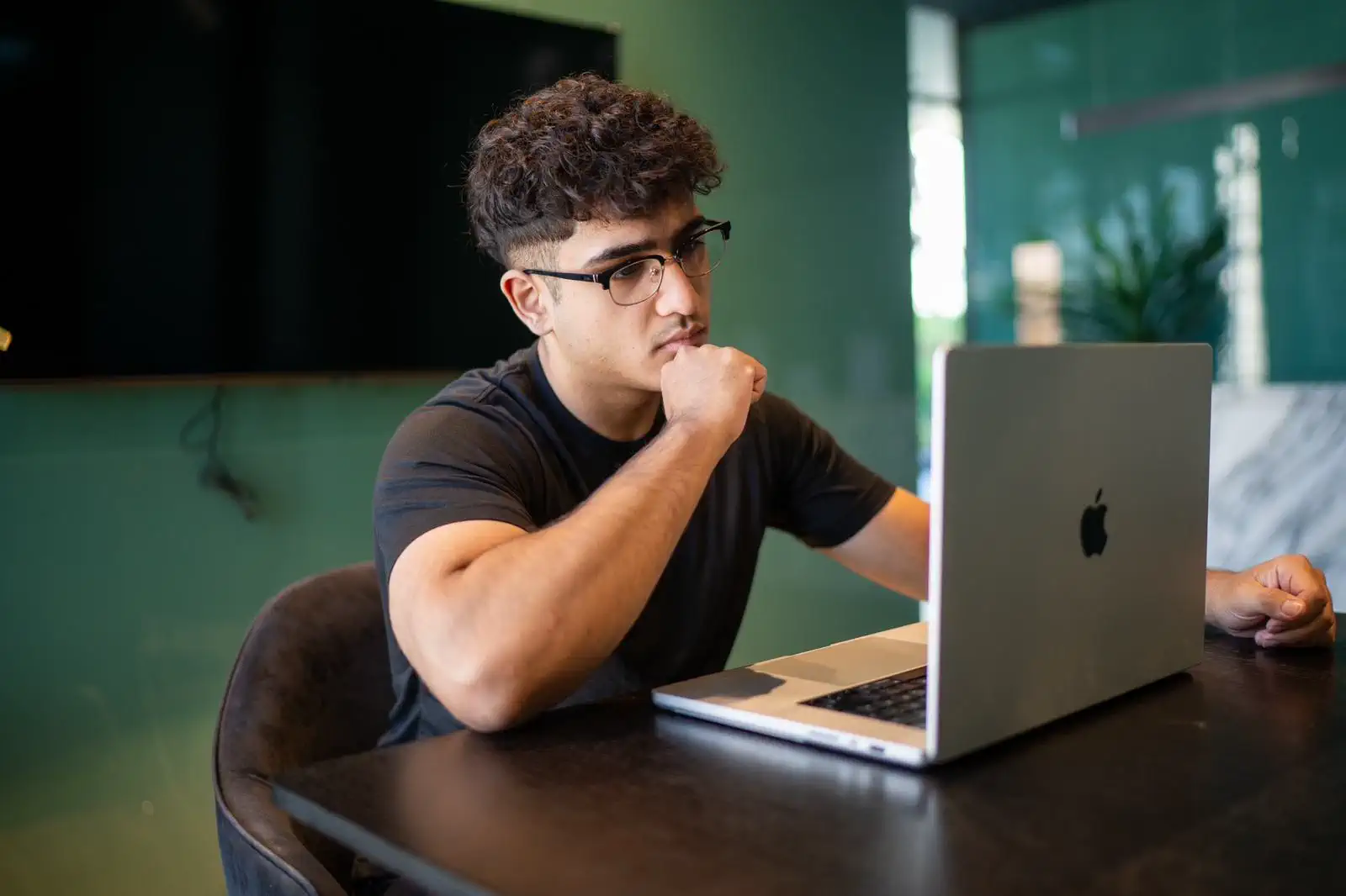 Client focused on a laptop during an online personal training session