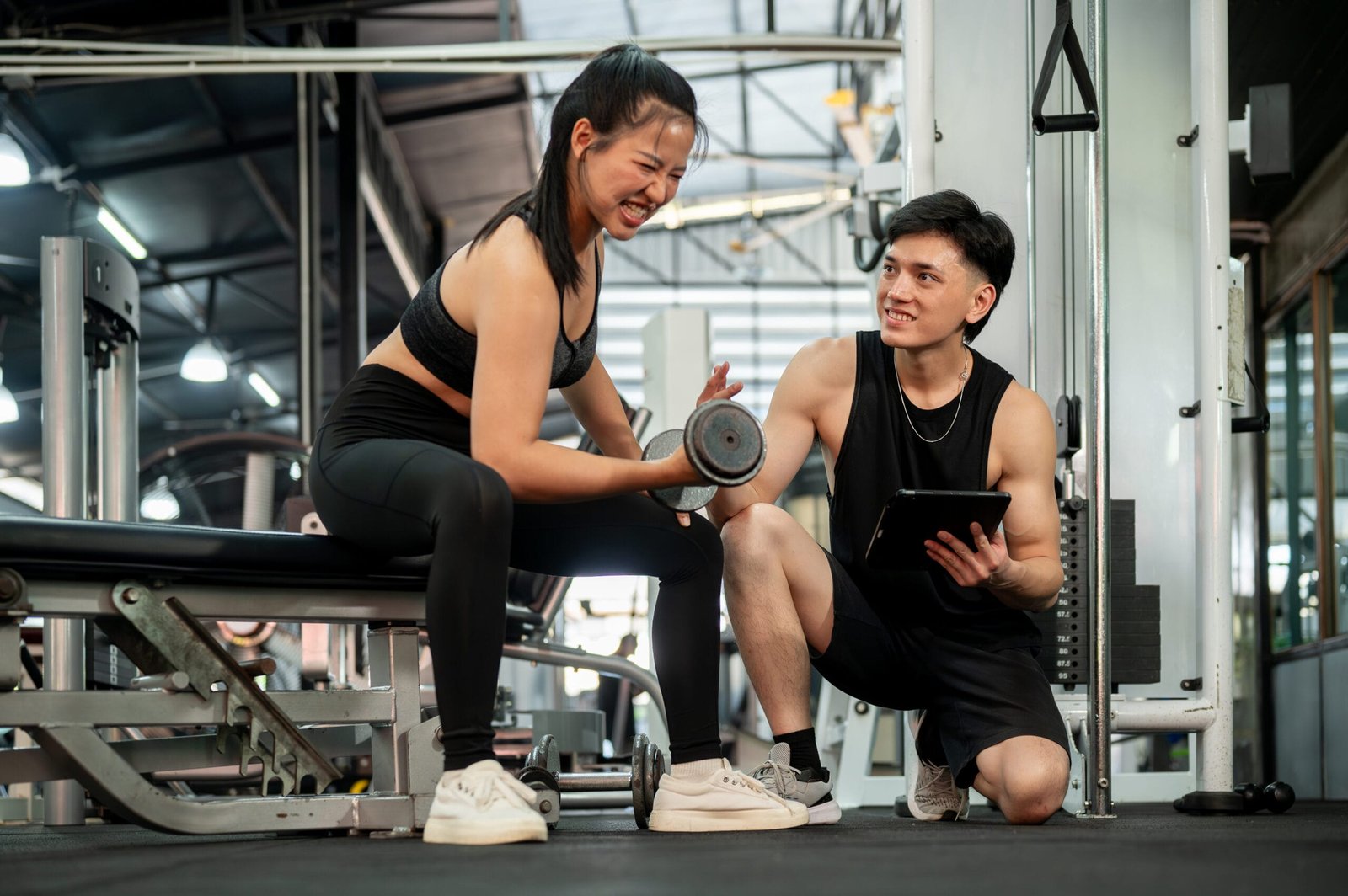 Personal trainer instructing a client on proper form