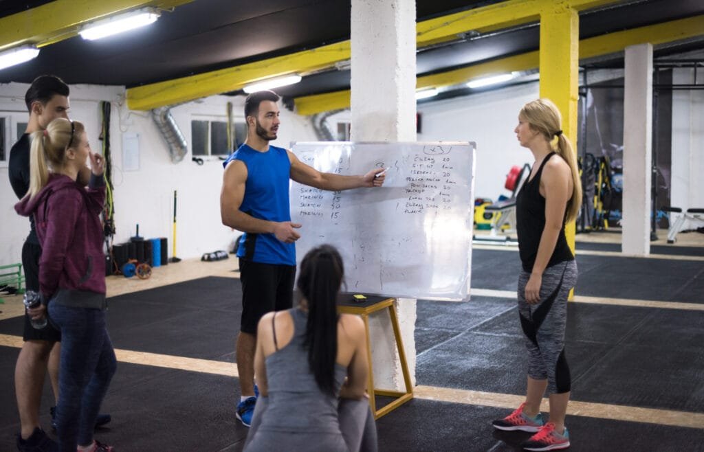 Group of athletes getting instructions from a trainer
