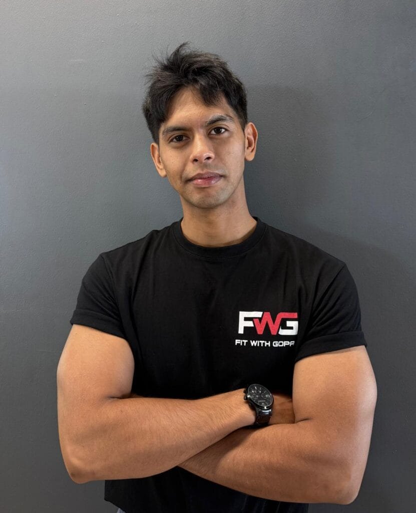 Ro-ed Abulkahir, FWG Strength & Hypertrophy Coach, arms crossed in an FWG t-shirt
